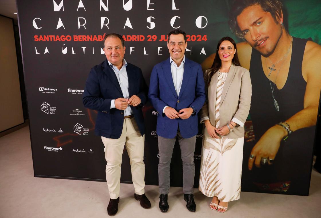 MADRID , 29/06/2024.- El presidente de Andalucía, Juan Manuel Moreno Bonilla (c), asiste junto al presidente de la Diputación de Huelva, David Toscano (i) y la presidenta de "Destino Huelva", Ana Delgado (d), hoy, 29 de junio de 2024, a un acto de presentación del nuevo logo de la campaña turística "Destino Huelva" antes del concierto del cantante Manu Carrasco, en el estadio Santiago Bernabéu, en Madrid. EFE/David Fernández