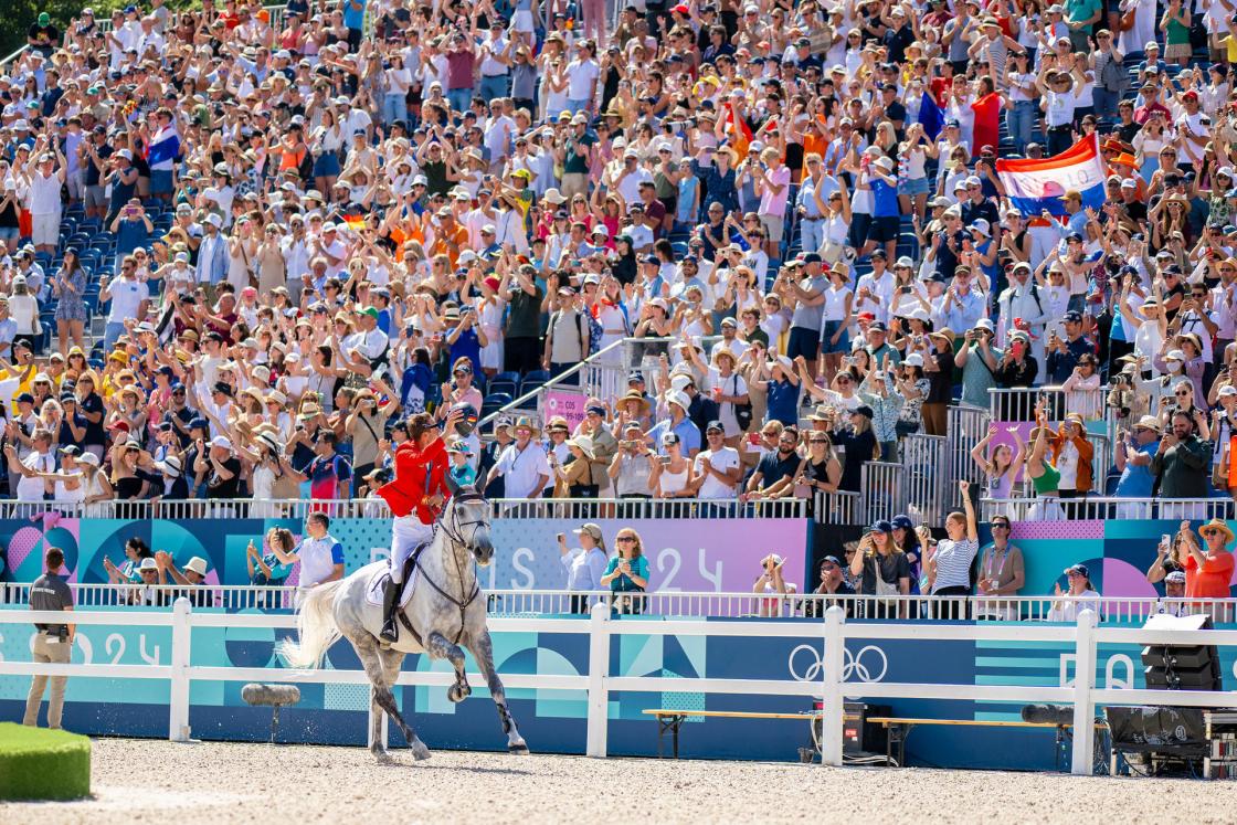 Christian Kukuk (GER) riding Checker 47 during the Lap of Honour after winning Gold in the Individual Show Jumping Final at the Chateau de Versailles for the Paris 2024 Olympic Games. Photo Credit: FEI/Benjamin Clark SOLO USO EDITORIAL