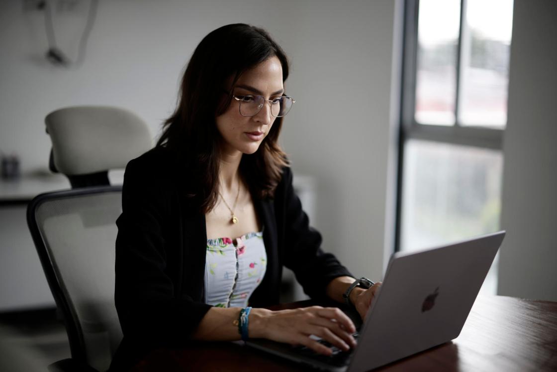 Biologist Mónica Espinoza, LATAM leader of Global Fishing Watch, works on her computer during an interview with EFE on October 3, 2024, in San José (Costa Rica). EFE/ Jeffrey Arguedas 