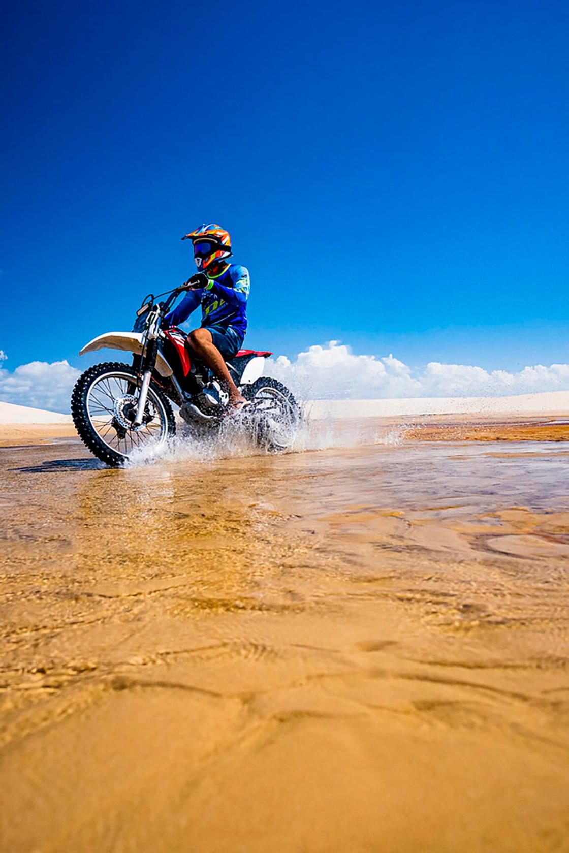 Photo courtesy of the Embratur and Sebrae showing a motorcyclist riding across a dune in Lençóis Maranhenses National Park. A desert of white dunes conceals thousands of freshwater lagoons with crystal-clear water: this is the surreal landscape of Lençóis Maranhenses, a paradise that is causing a sensation on social media and has become a symbol of sustainable tourism in Brazil. EFE/Embratur and Sebrae /FOR EDITORIAL USE ONLY, NOT FOR SALE/ONLY AVAILABLE TO ILLUSTRATE THE ACCOMPANYING NEWS ITEM (MANDATORY CREDIT) HIGHEST QUALITY AVAILABLE