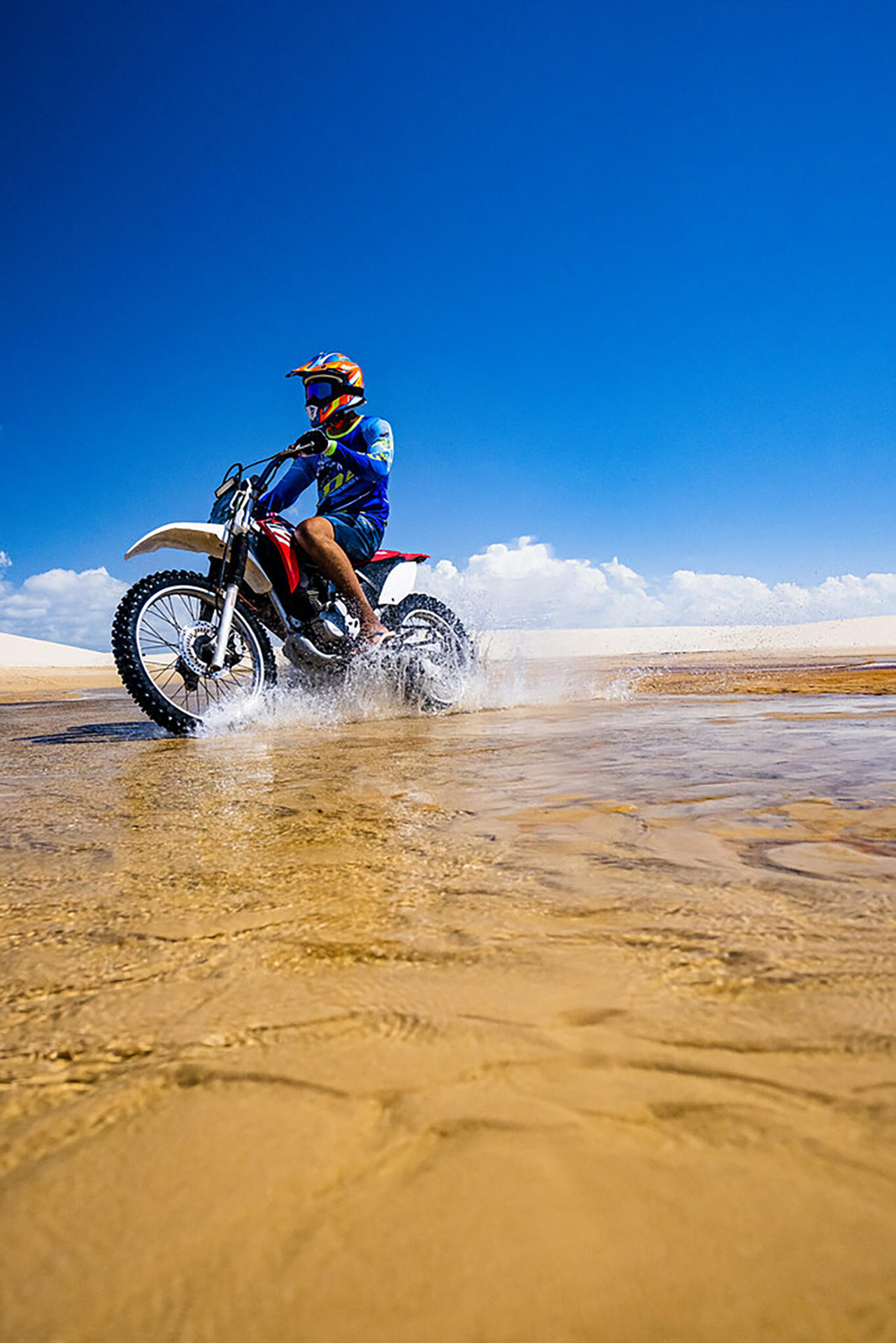 Photo courtesy of the Embratur and Sebrae showing a motorcyclist riding across a dune in Lençóis Maranhenses National Park. A desert of white dunes conceals thousands of freshwater lagoons with crystal-clear water: this is the surreal landscape of Lençóis Maranhenses, a paradise that is causing a sensation on social media and has become a symbol of sustainable tourism in Brazil. EFE/Embratur and Sebrae /FOR EDITORIAL USE ONLY, NOT FOR SALE/ONLY AVAILABLE TO ILLUSTRATE THE ACCOMPANYING NEWS ITEM (MANDATORY CREDIT) HIGHEST QUALITY AVAILABLE