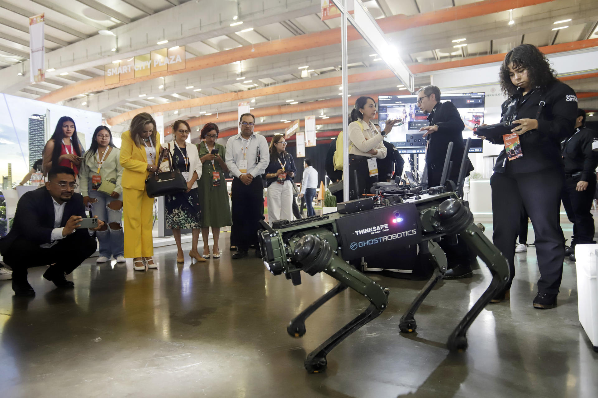 Personas observan un robot durante la inauguración del SmartCity Expo Latam Congress este martes, en la ciudad de Puebla (México). EFE/ Hilda Ríos